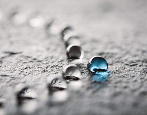 Macro photography of water drops on a black slate. Great image for nature and any water subject area. Photo captured with a Canon MP-E 65mm f/2.8 1-5x  at f/8.0.